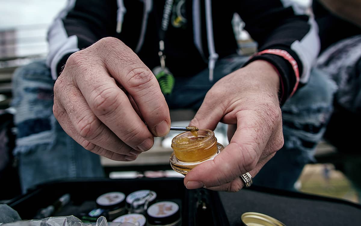 a man with a small container showing what are dabs