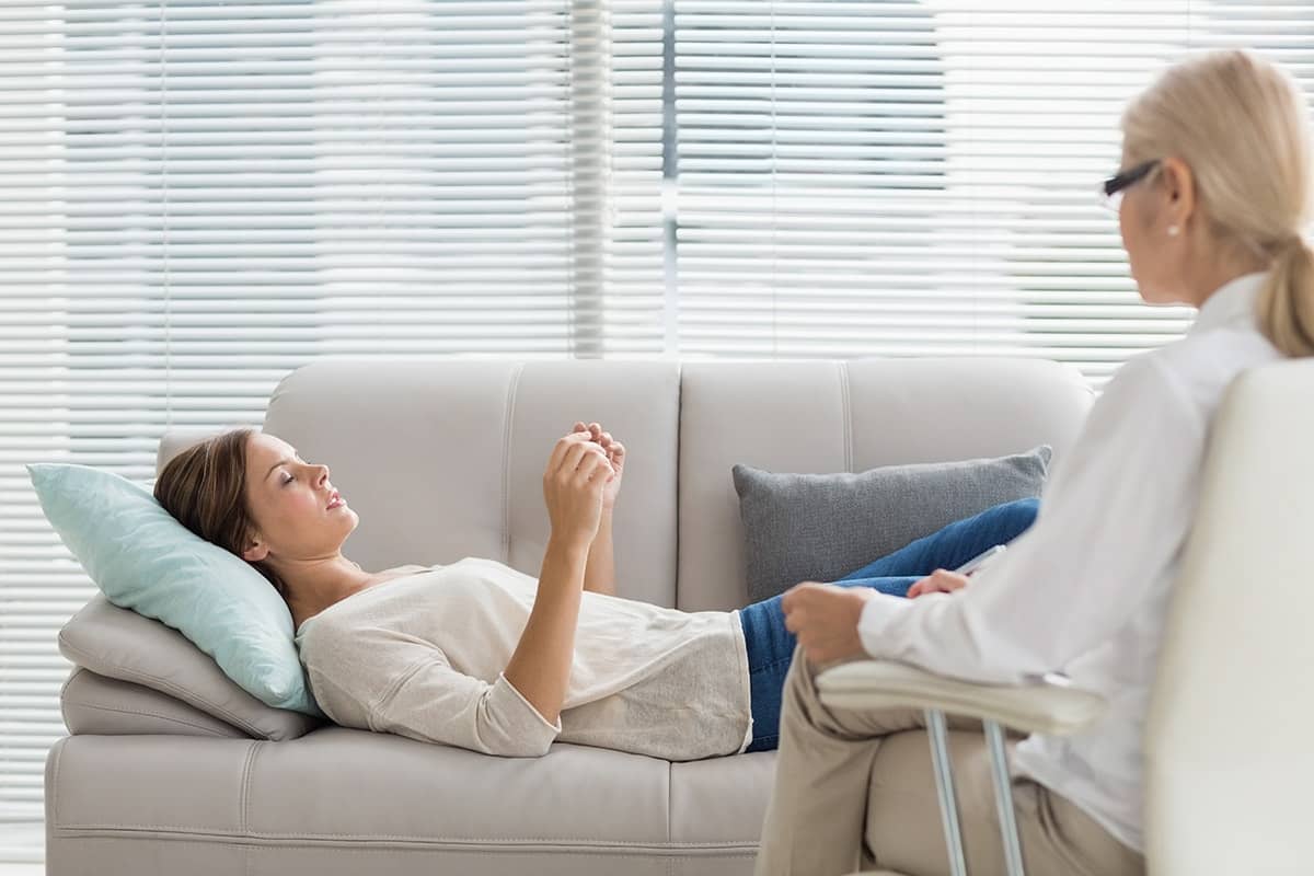 Woman on couch receives therapy for her co-occurring disorders