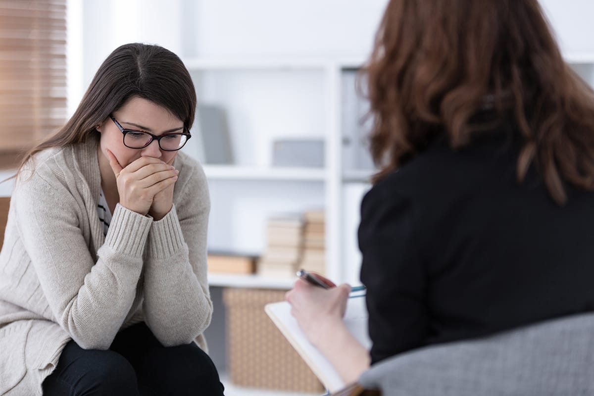 a woman talking to her doctor about acute stress disorder