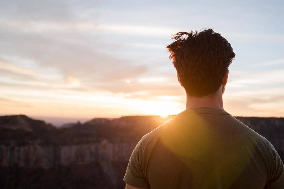 man looking at sunset celebrating a sober new year
