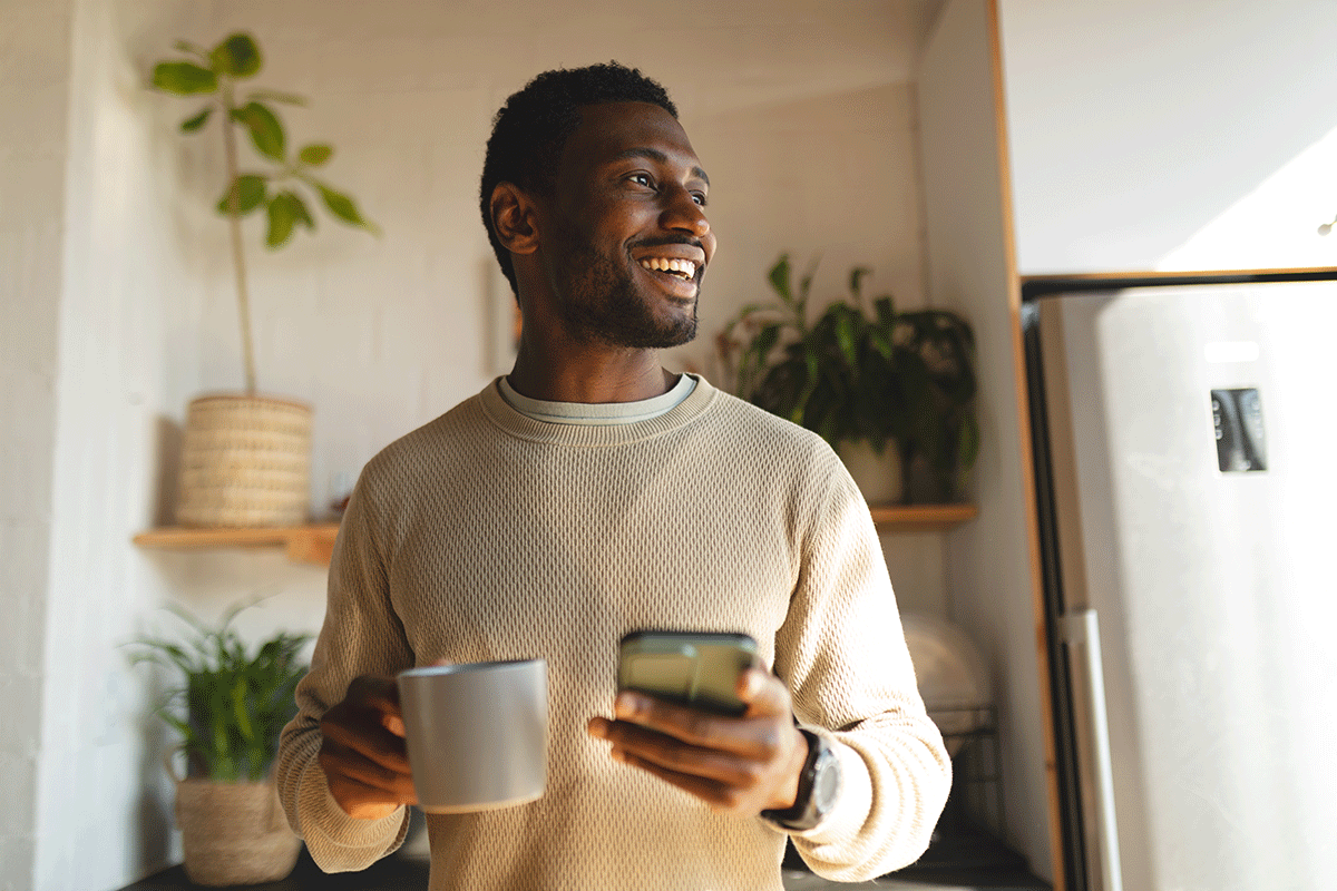 man holding a mug texting about why he stayed sober