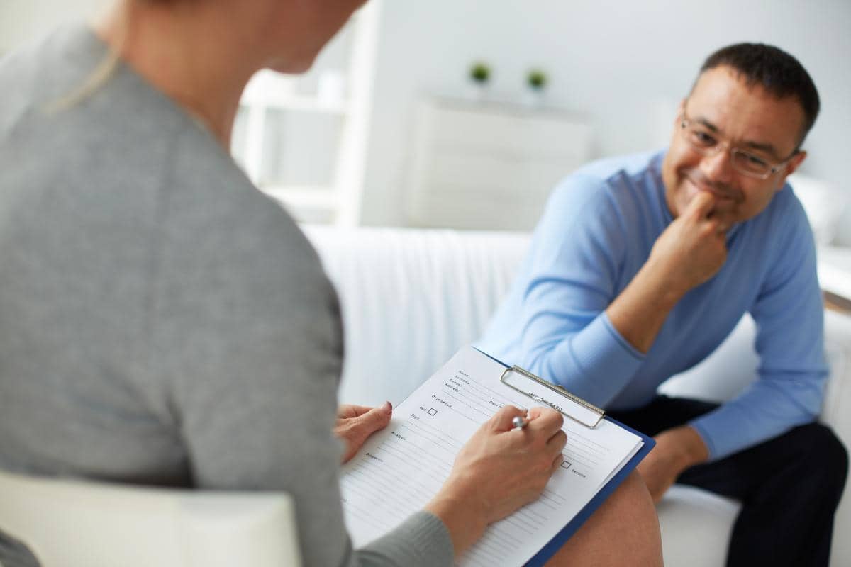 male speaking with therapist