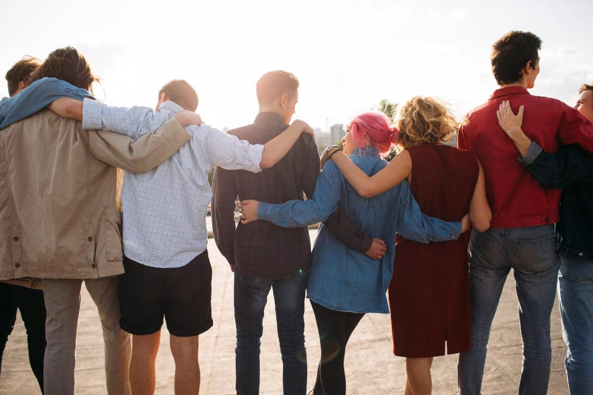 a group of people in a line with arms around each other discussing private drug rehab centers in Northern Florida