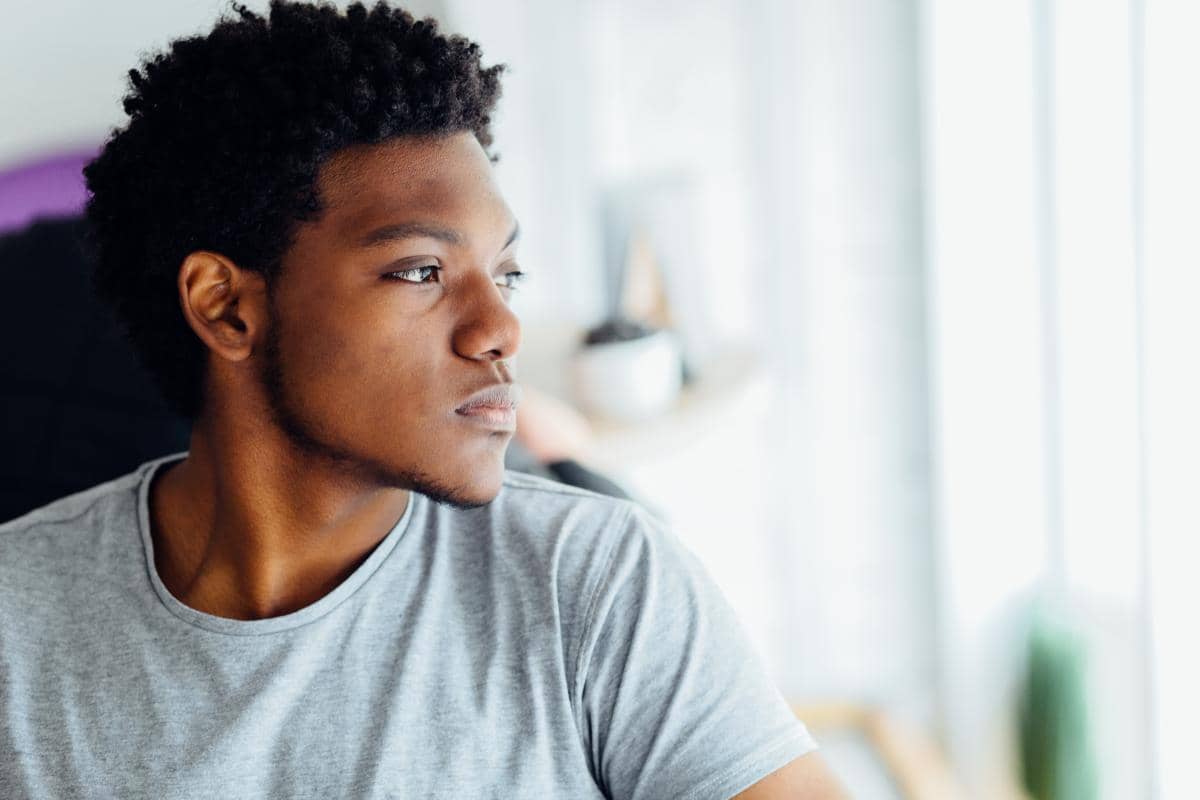 a man sitting and thinking about is rapid opioid detox safe