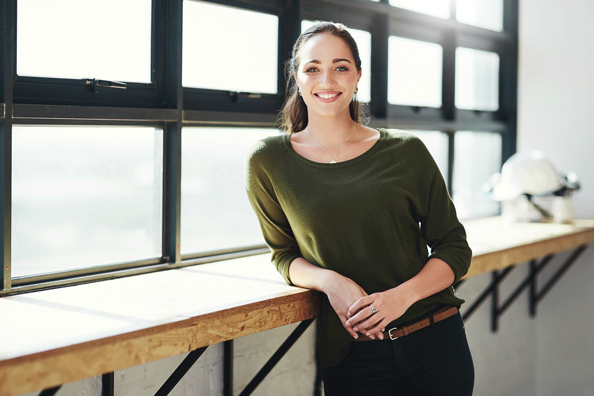 woman in green top thinking about the definition of sober