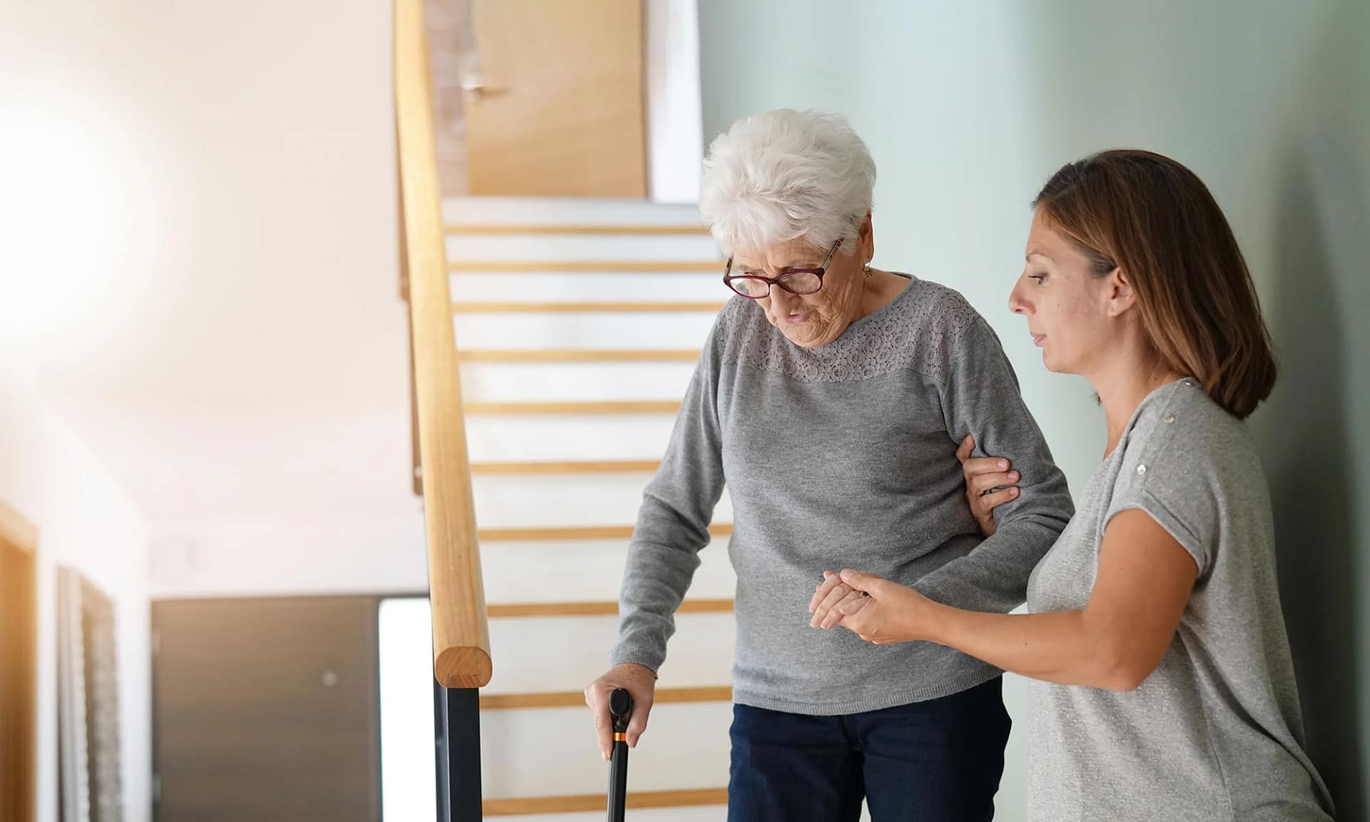 Assisting senior woman on stairs