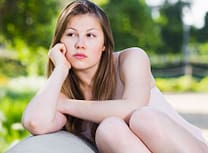 Sad young woman want to learn how to stop addiction at Serenity House Detox & Recovery.