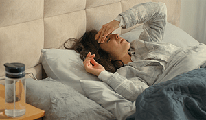 woman laying in bed thinking about the types of drinking culture