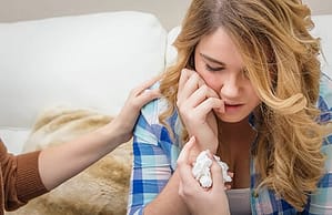 Young girl with mother's hand on shoulder knows she need heroin detox treatment.