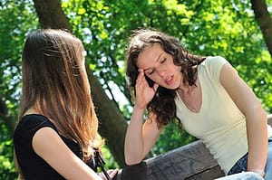 Addiction sponsor and young woman talking about living life without drugs.