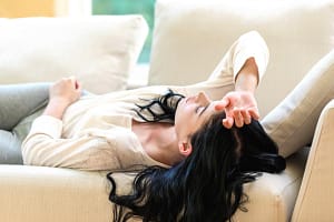 woman on couch experiencing stages of benzo withdrawal