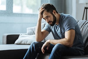 a man deals with a hangover in bed, possibly a sign of a secret drinking problem