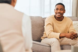 a man listens to a therapist in a cocaine addiction treatment center