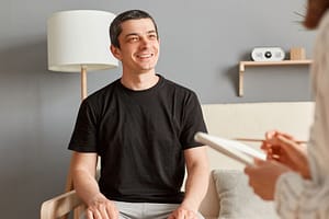 a man smiles during OCD treatment