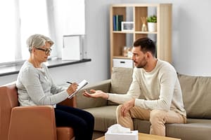 a man talks to a therapist during bipolar disorder treatment