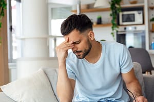 a man going through fentanyl withdrawal holds his head