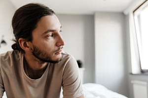 a person struggling with cross addiction sits and thinks