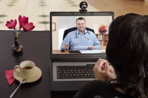 a woman talking to a doctor displaying a telehealth intensive outpatient program