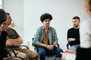 group of young men sitting in group therapy as part of addiction therapy services