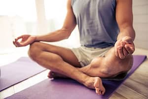 Man practicing yoga at inpatient detox