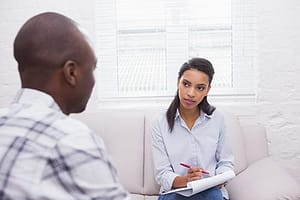 Intake counselor talking to man with ecstasy addiction who needs an ecstasy detox program in FL