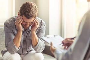 Man with headache most likely needs a vicodin detox program in FL for his addiction