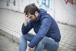 Distressed man on curb worried about suboxone abuse