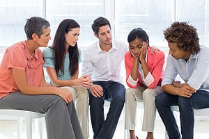 woman talking in co-ed group therapy session at a south florida residential treatment center