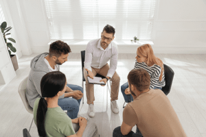 People chat and connect in group therapy program