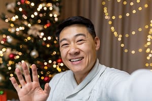 man waves at camera while explaining ways to maintain your recovery routine during the holidays