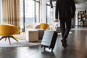 person with luggage traveling for alcohol addiction treatment near me