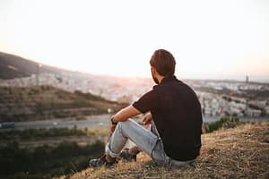 Lonely guy on a hill needing a Florida center for recovery for addiction.