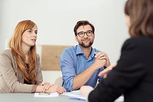 Two people talking to addiction specialist about drug detox programs.