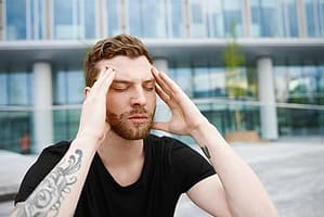 man with screaming headache knows he has a personal opiate crisis