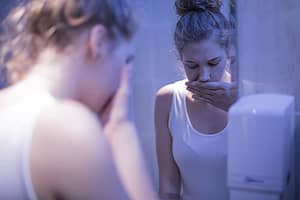 Young woman in mirror image sick of her substance abuse and addiction.