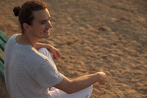 Happy guy on beach knows what is detoxification