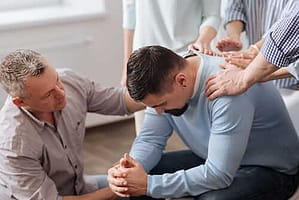 Group supporting a new man in a methadone treatment program