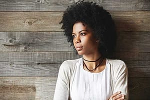 Worried woman against wood wall needs to know what is carfentanil