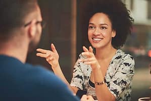 Smiling woman facing counselor happy to be dealing with her bipolar disorder and addiction