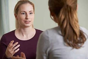 Two woman exchanging their stories in an opioid detox center during an opioid detox program