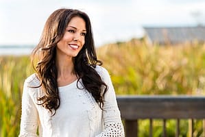 Smiling woman on a deck staying sober during Thanksgiving