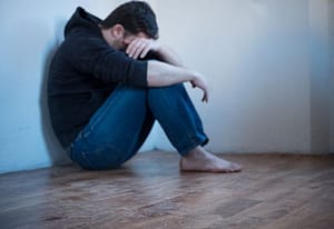 Young man despairing about heroin addiction and now methadone withdrawal