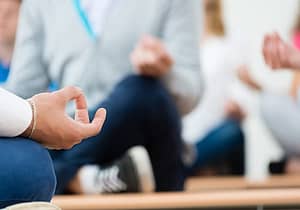 people meditating in a holistic drug rehab center