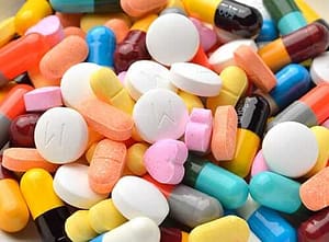 Pile of pills some of which will show the effects of ecstasy