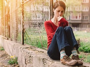 Young frightened woman on a wall worrying about her crystal meth addiction.