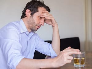 Types of alcoholics include chronic severe which may this man with head in hand and drink.