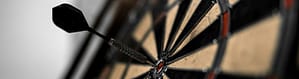 dart board with a dart in the bullseye