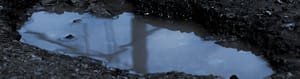 puddle in cracked asphalt