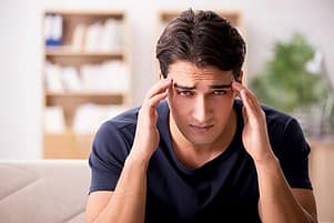 Signs of Alcoholism are clear to this man with headache.