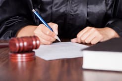 Judge signing paper for drug treatment court